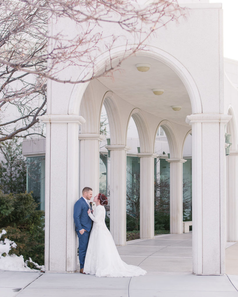 kayla and evan under bountiful temple arches on wedding day